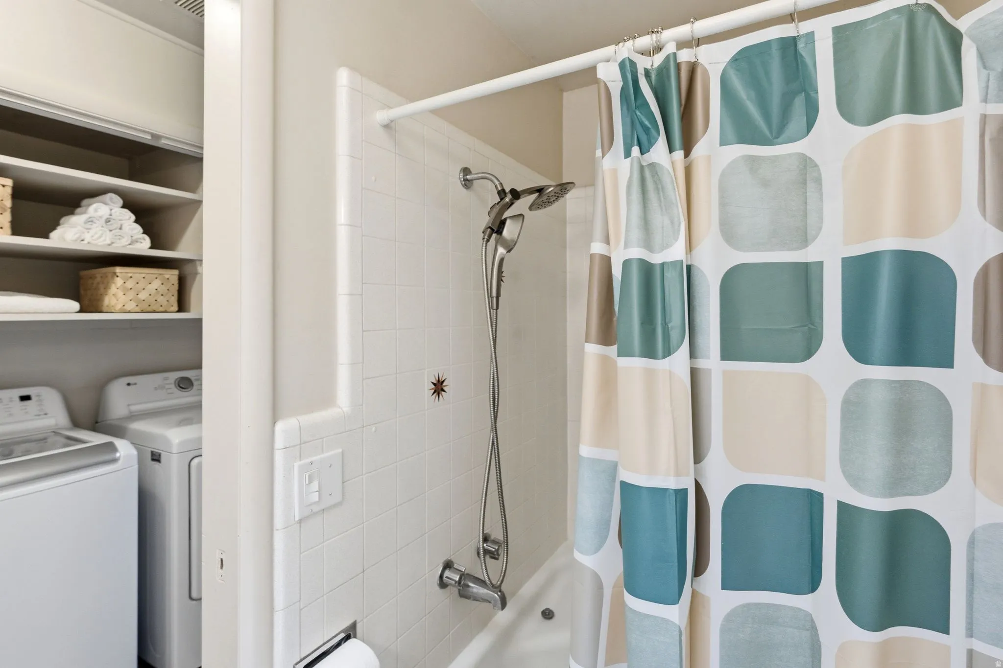 White subway tile bath surround with an integrated shower and tub