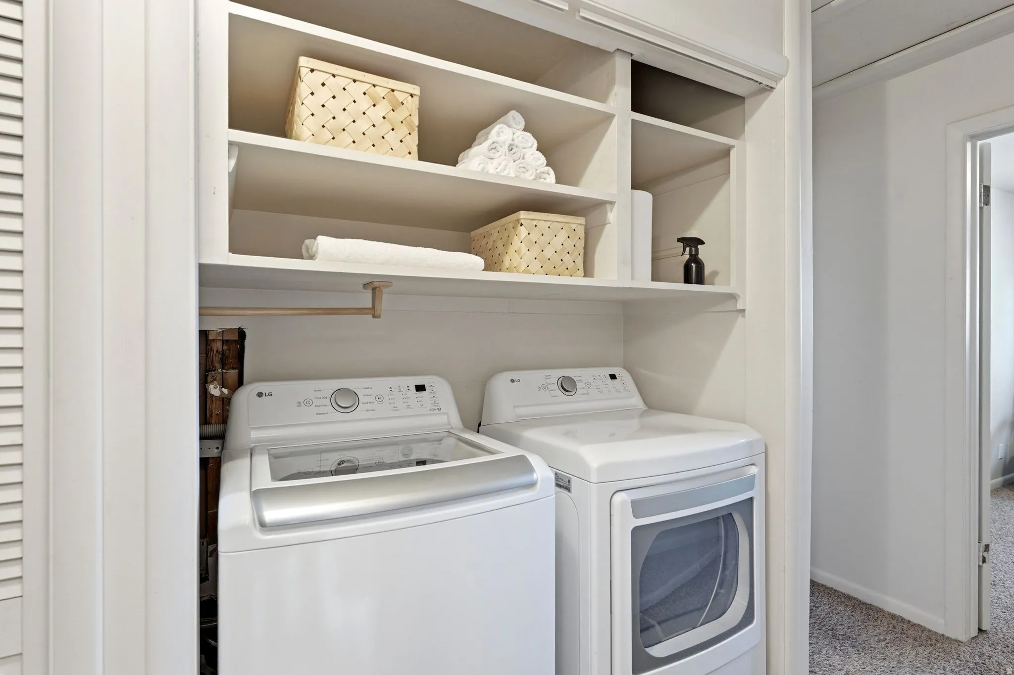 Dedicated laundry area featuring a top-load washing machine and front-load dryer