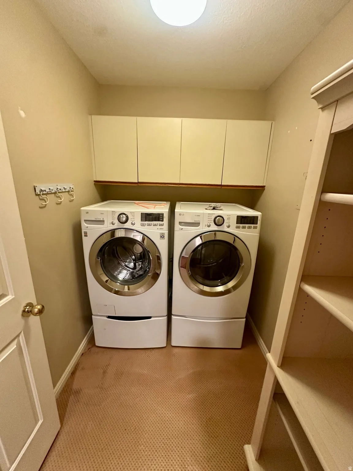Dedicated laundry area featuring front-loading appliances