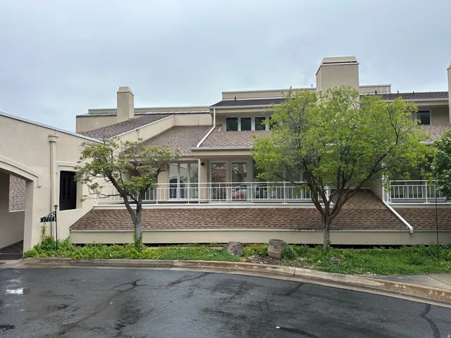Multi-level exterior featuring light-toned stucco and prominent chimneys
