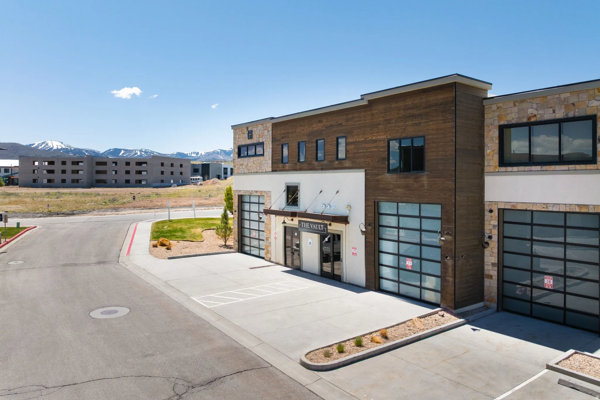 Modern commercial building featuring stone and wood-finish siding