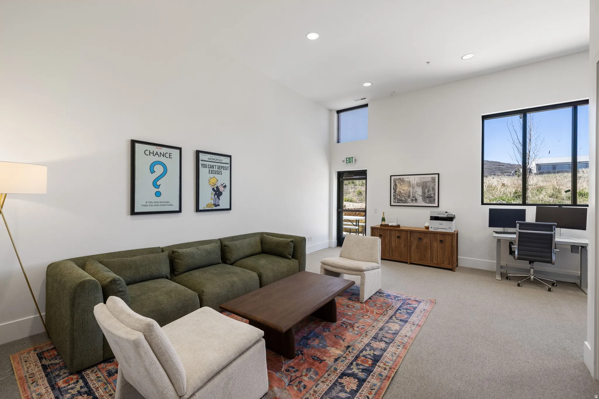 Spacious room with high ceilings, recessed lighting, and large windows