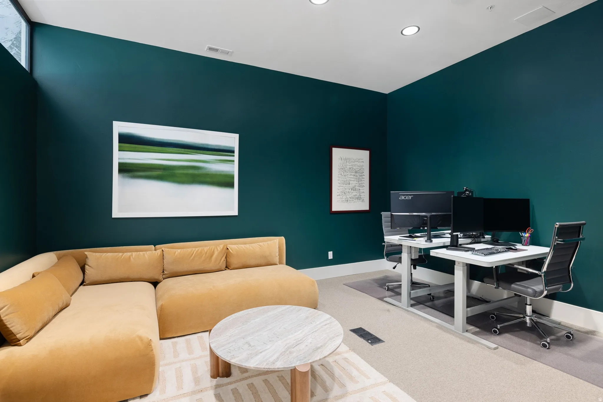 Spacious room featuring deep teal walls, recessed lighting, high ceilings, and light-colored carpeting