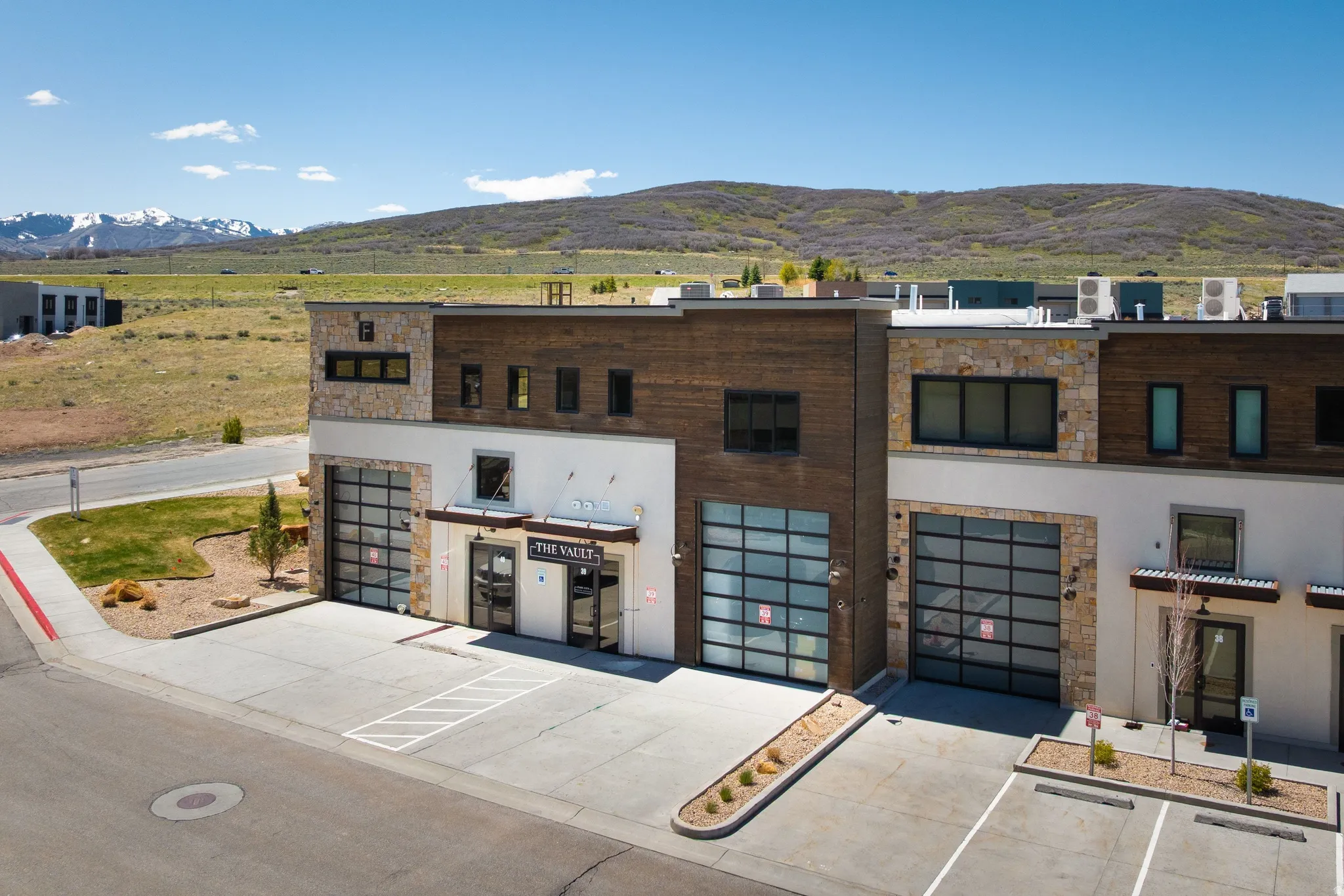 Multi-level commercial structure featuring a stone and wood-panel facade