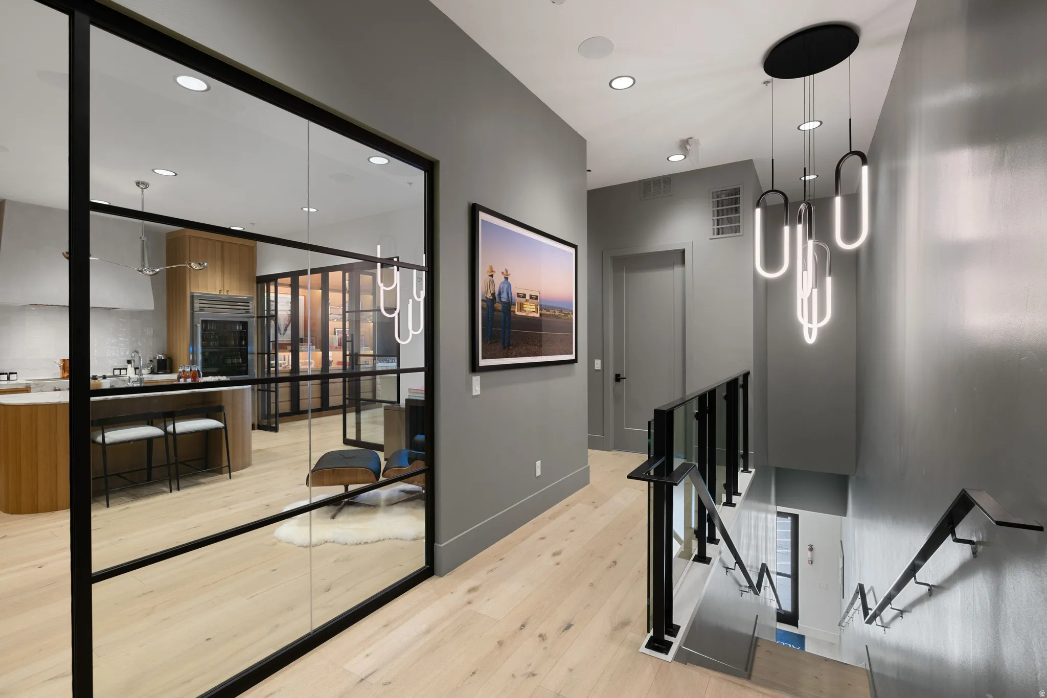 Hardwood-finish flooring extending through the hallway and into the visible living area