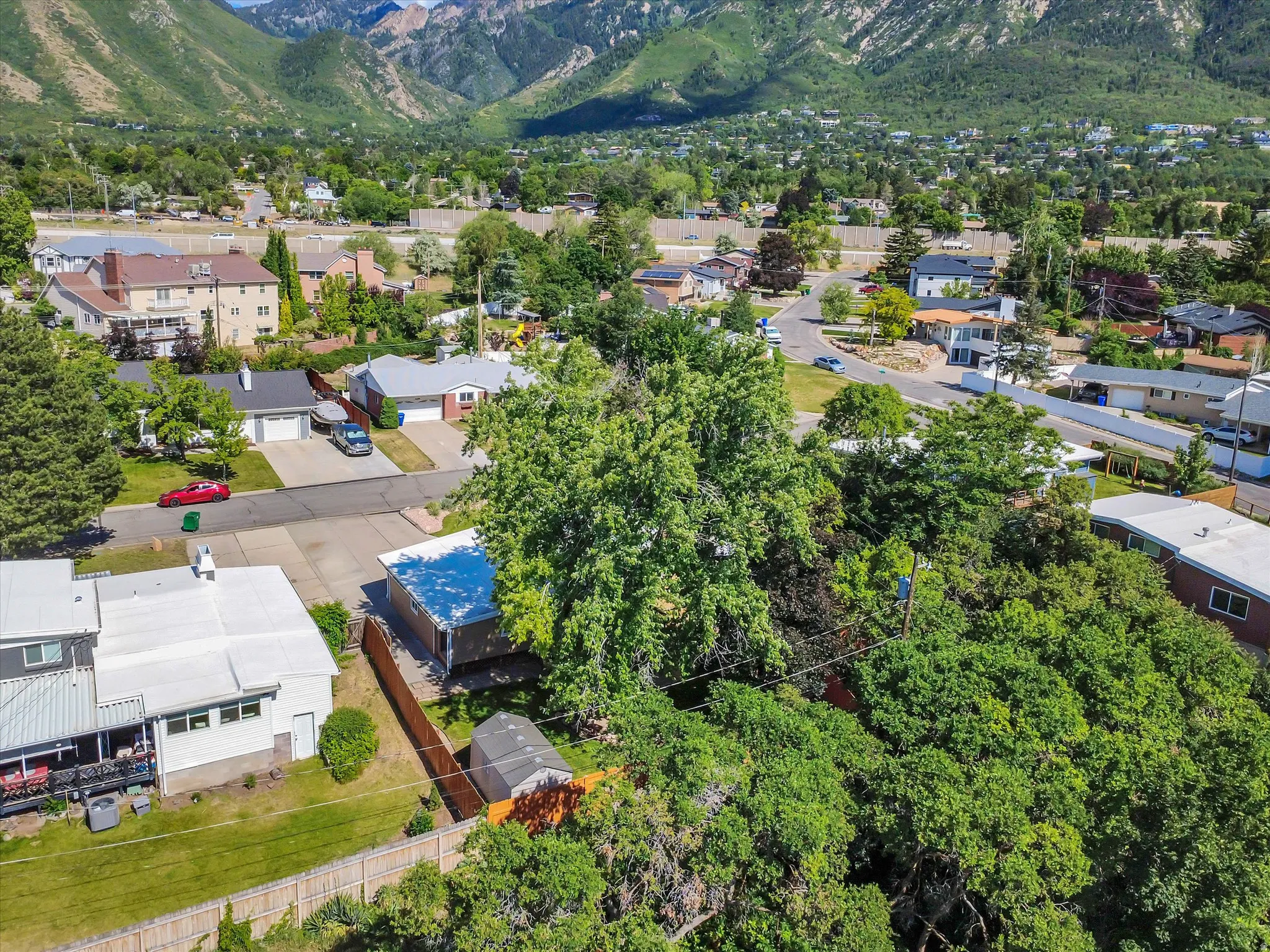 Aerial perspective showcasing a residential neighborhood with a mountainous backdrop