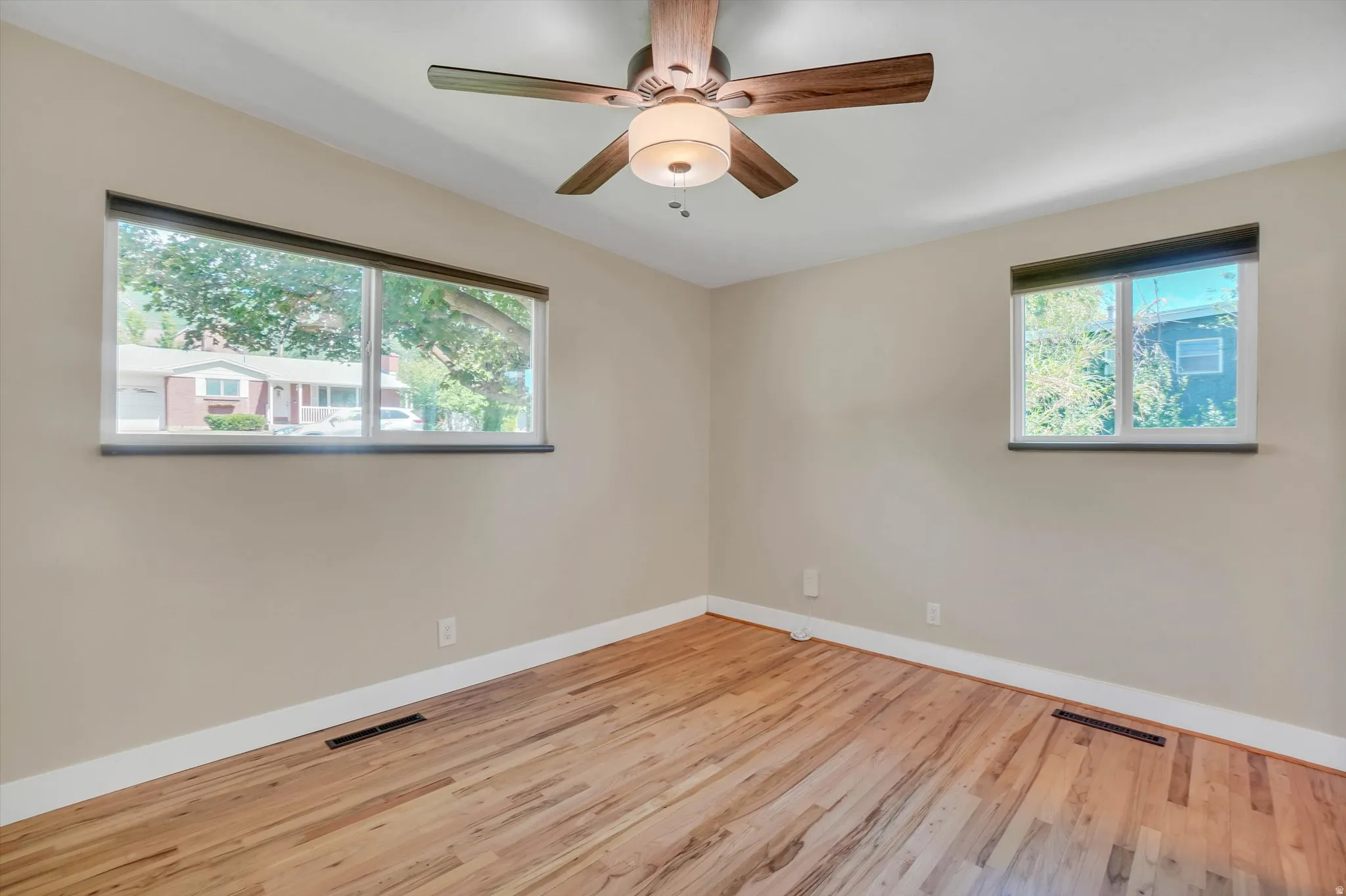 Warm wood-finish flooring complemented by neutral wall tones