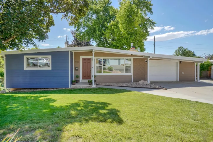 Mid-century modern exterior featuring a vibrant blue and tan siding combination