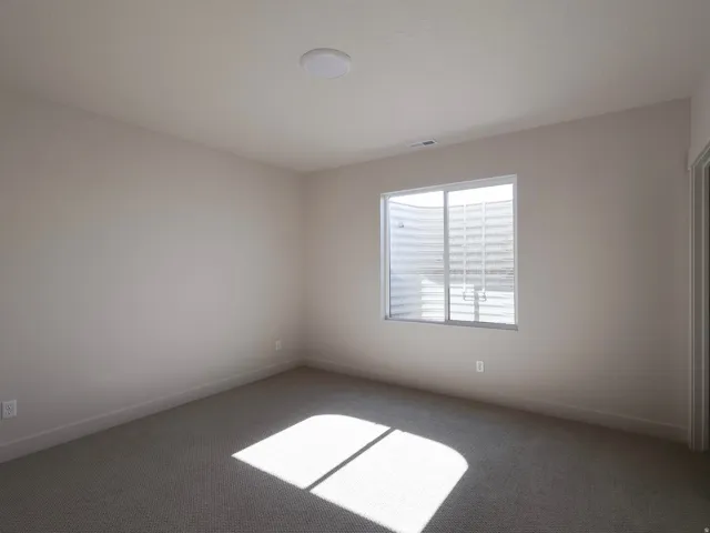 Neutral wall paint, recessed lighting, and carpeted flooring