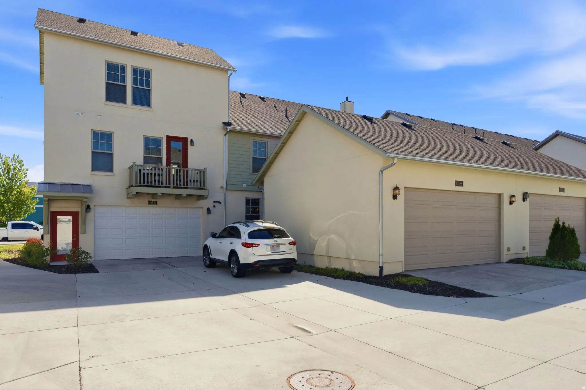 Garage is just to the right of the white car