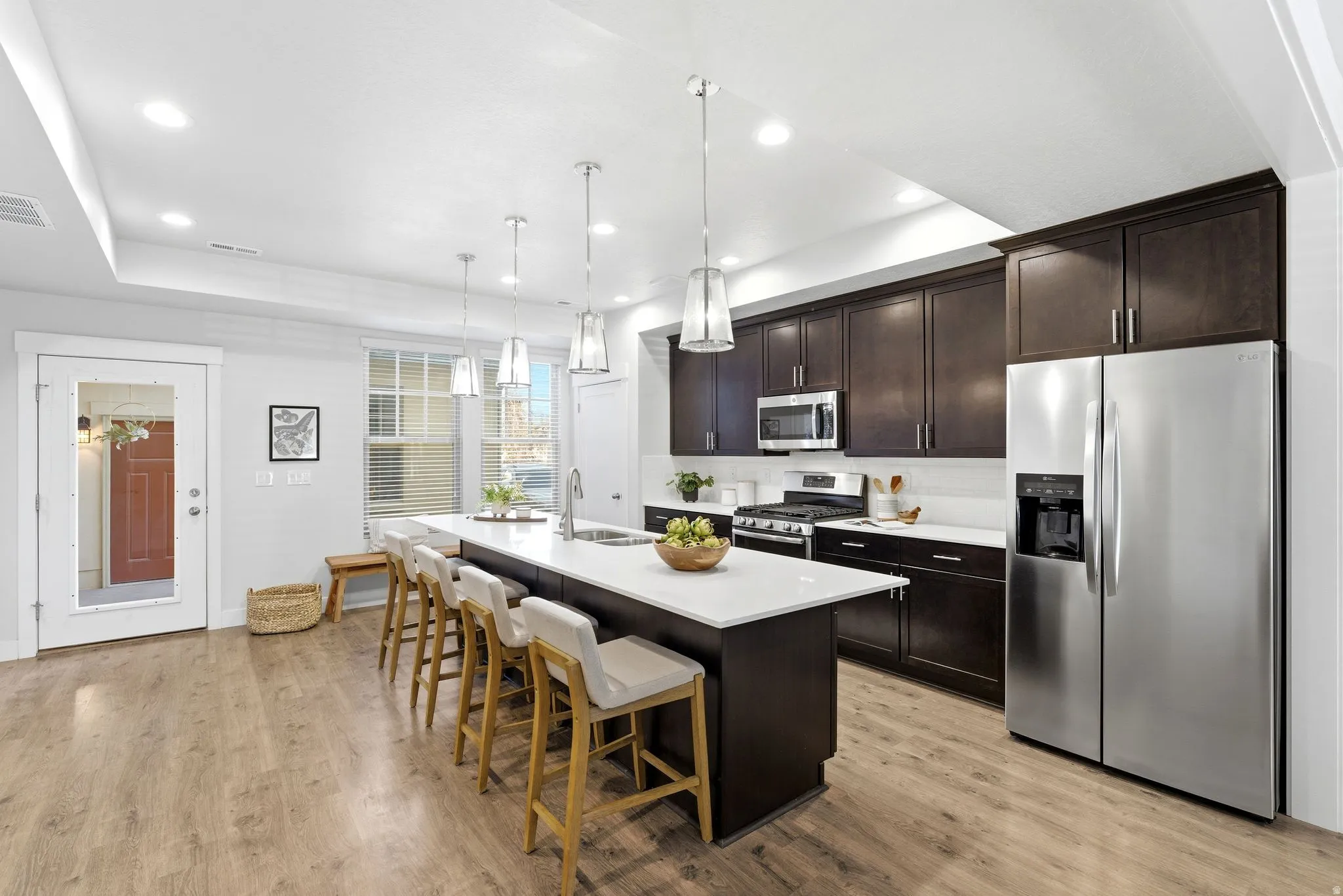 Open-concept kitchen featuring a quartz countertops and bar seating