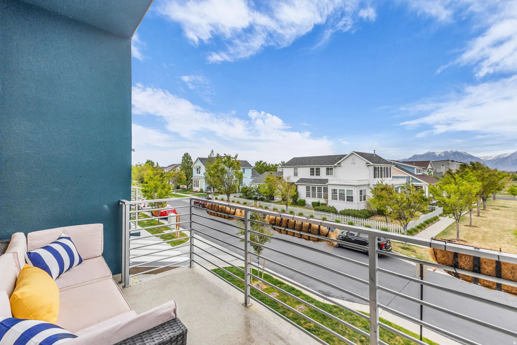 Private balcony with a concrete floor and a contemporary metal railing