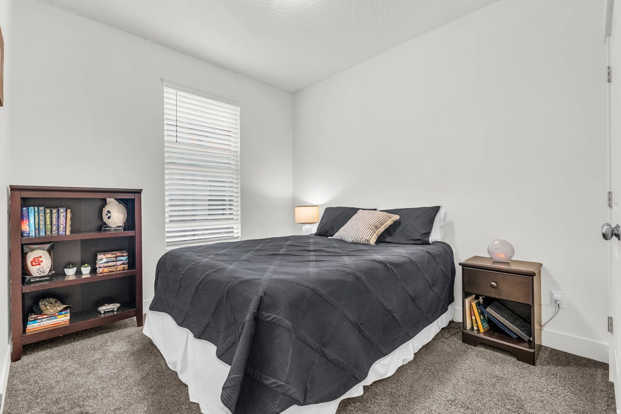Bedroom featuring soft gray carpeting and crisp white walls