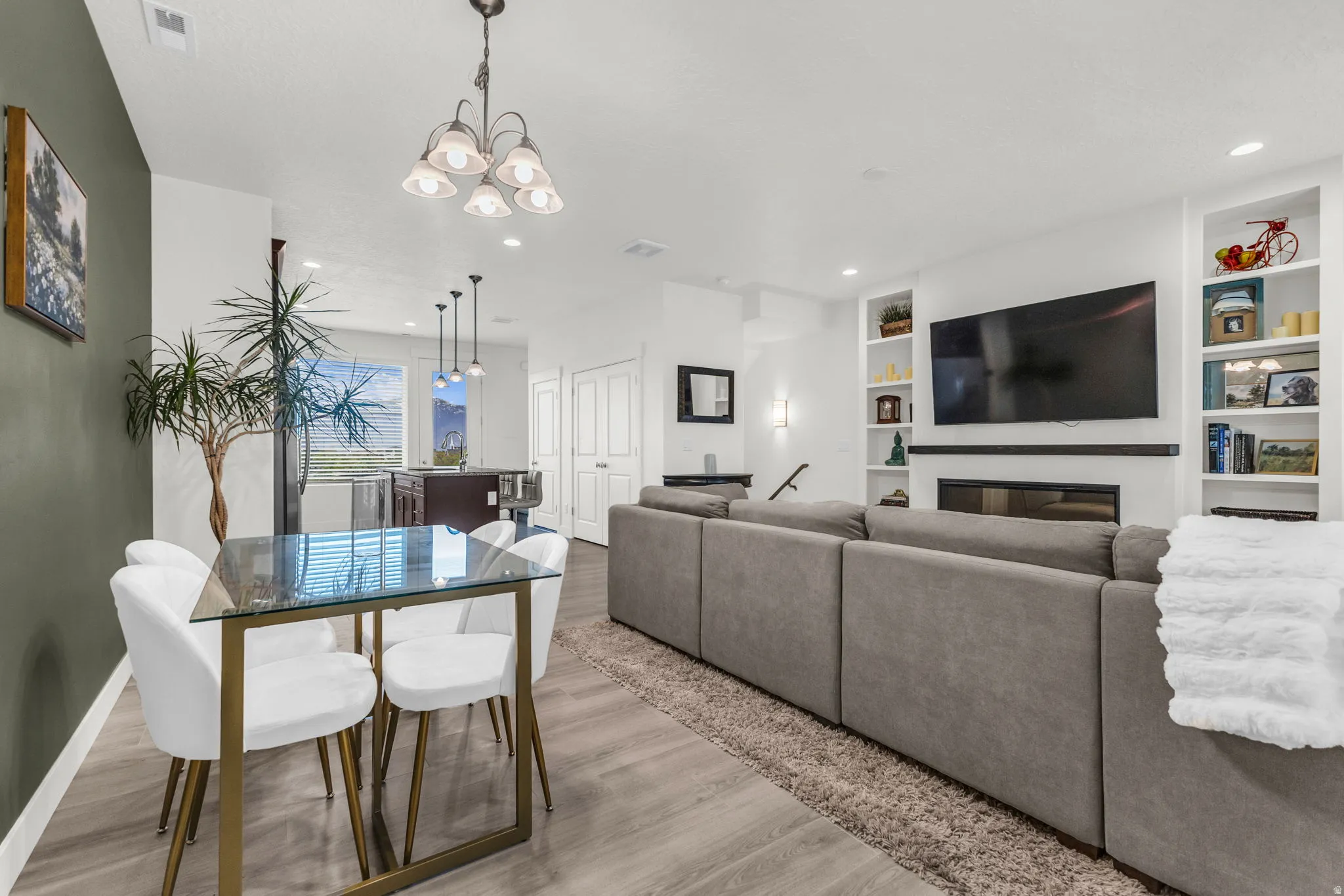 Open-concept living area with wood-finish flooring