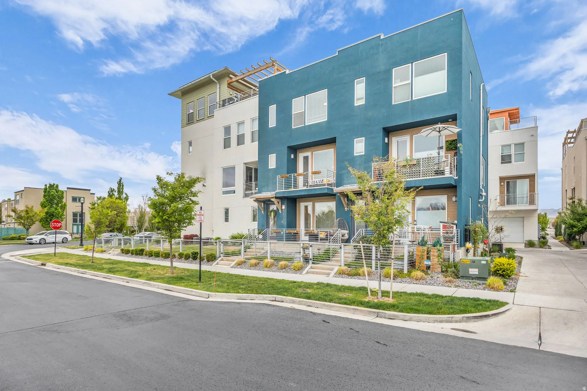 Contemporary multi-level residence featuring a distinctive blue facade and white trim accents