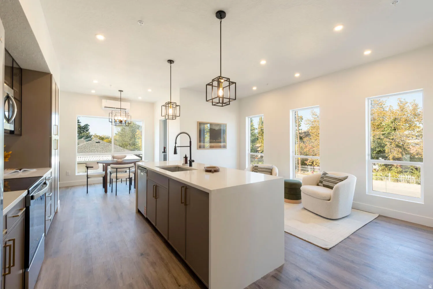 Kitchen island with an undermount sink, gooseneck faucet, and pendant lighting