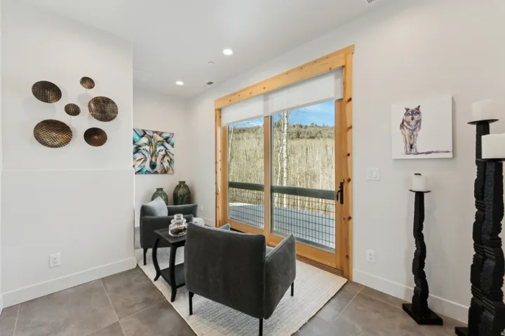 Expansive glass sliding door with natural wood framing