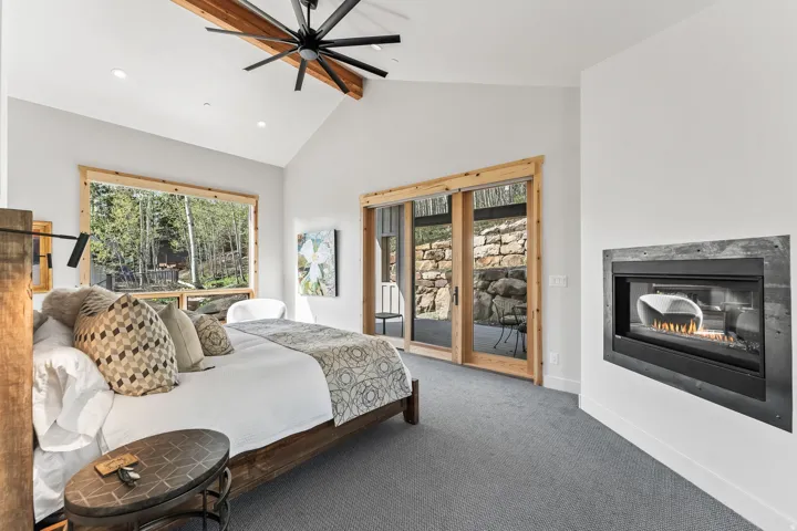 Vaulted ceilings with exposed wood beams and a large ceiling fan