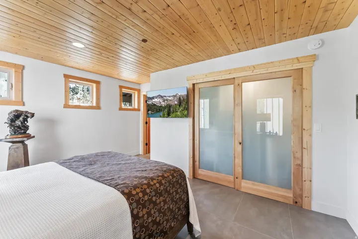 Wood-finish plank ceiling with recessed lighting