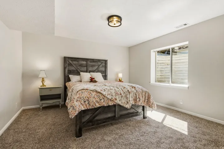 Carpeted room with a ceiling-mounted light fixture and a window