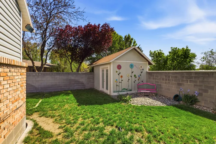 Expansive grass lawn bordered by a block privacy wall