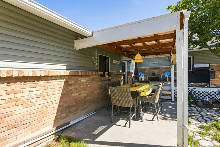 Covered patio with a concrete surface and exposed wood beam ceiling