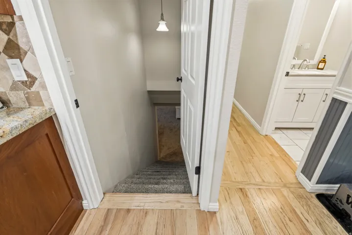 Light wood-finish flooring extending from a hallway entryway
