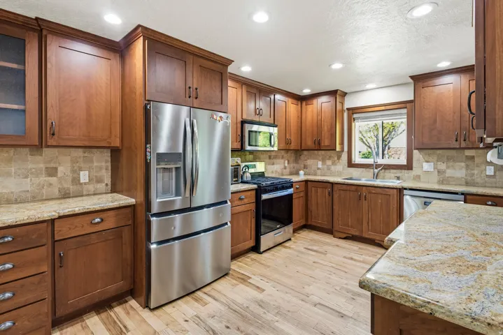 Kitchen featuring wood-finish flooring, recessed lighting, and a window with outdoor scenery