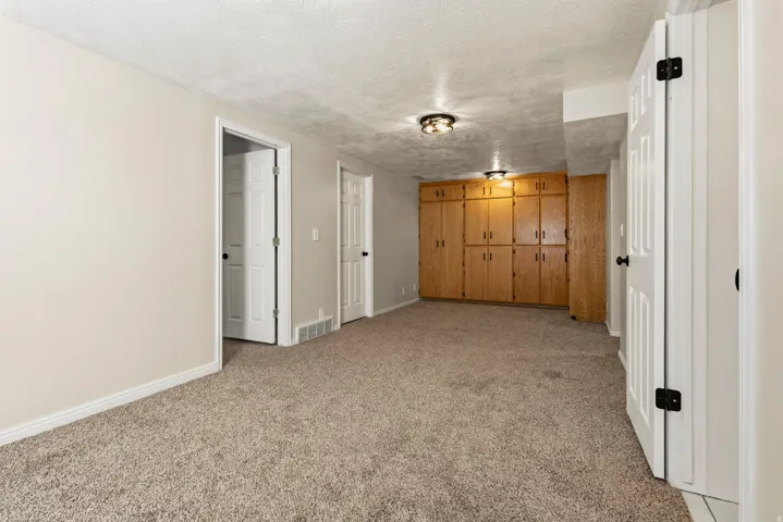 Plush carpet flooring complements light-toned walls