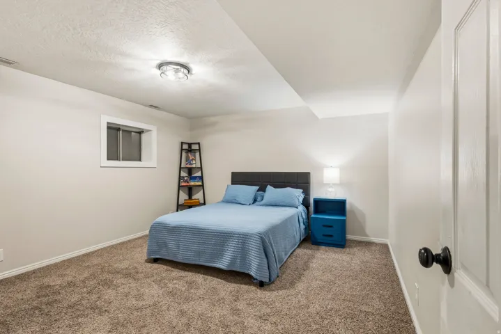 Carpeted room with a recessed window, white baseboards, and a flush mount ceiling light fixture