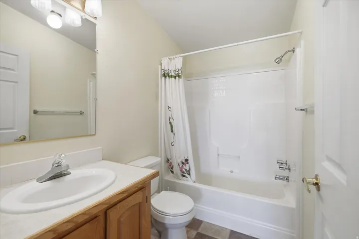 Bathroom featuring a single-sink vanity with wood-finish cabinetry and a white countertop
