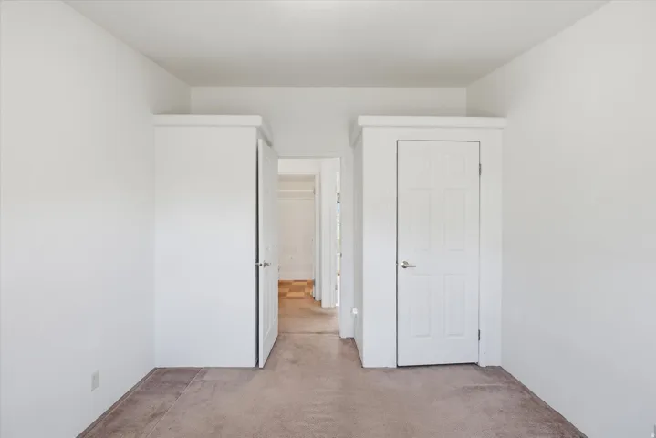 Neutral-toned carpeting paired with white painted walls
