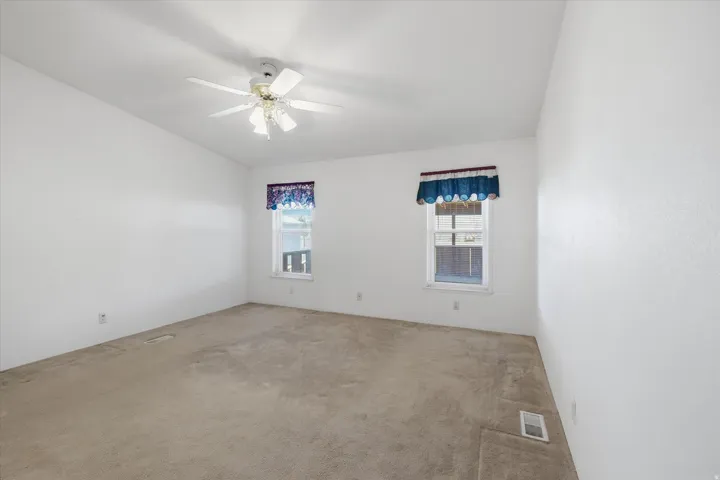 Neutral wall tones complement the neutral carpet throughout this room
