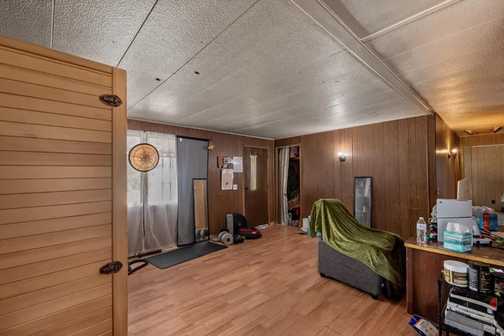 Wood-finish flooring complemented by wood paneling on walls