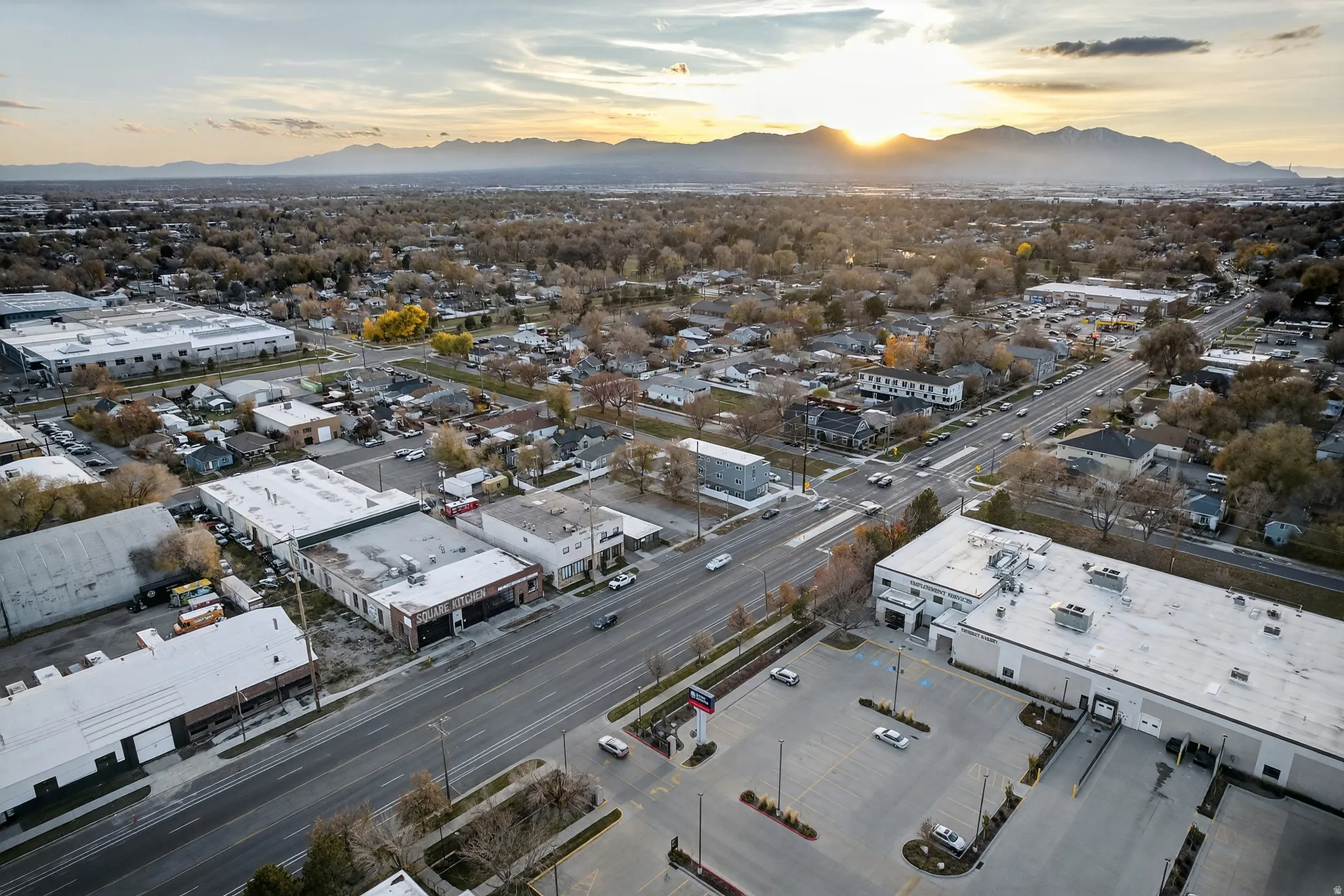 Expansive aerial perspective showcasing a commercial property with multiple buildings, surface parking, and a prominent loading dock