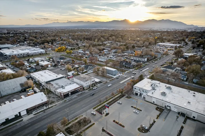 Expansive aerial perspective showcasing a commercial property with multiple buildings, surface parking, and a prominent loading dock