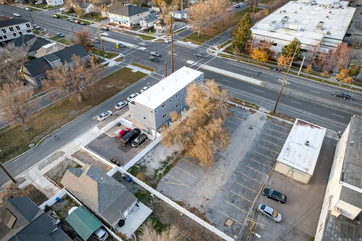 Multi-level building featuring a flat roof and a light-colored facade