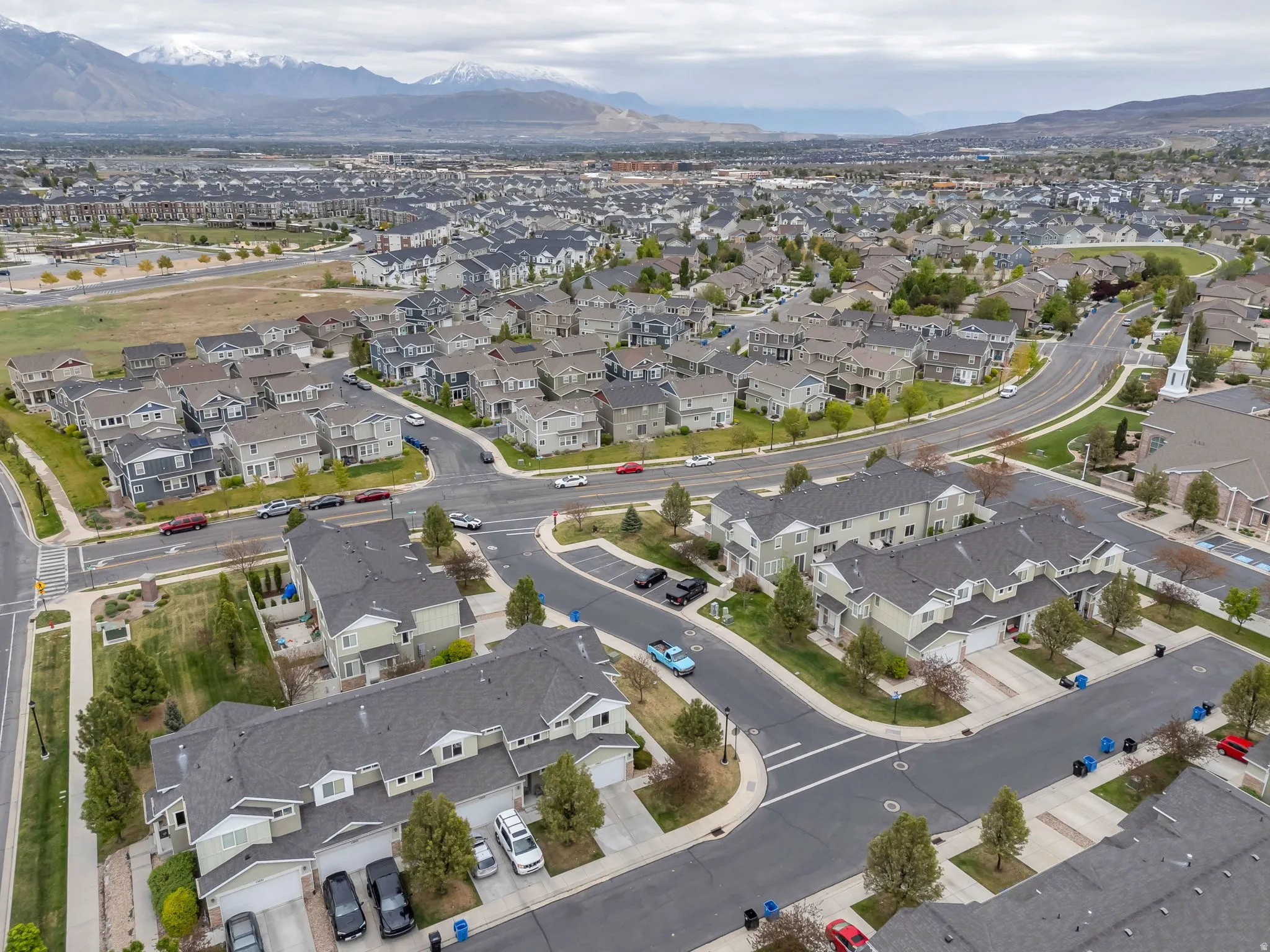 Aerial perspective of a developed residential community featuring a network of streets and varying home styles