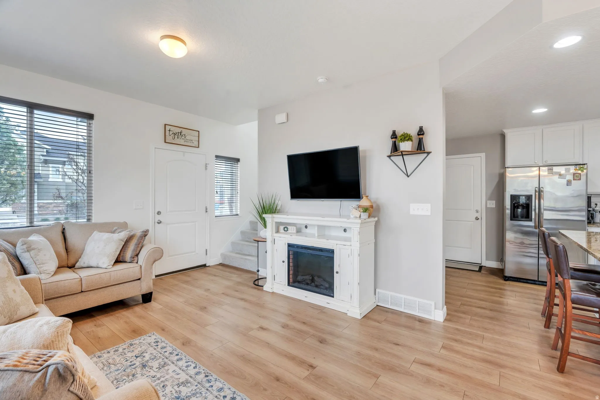 Light wood-finish flooring throughout, complemented by light gray wall tones
