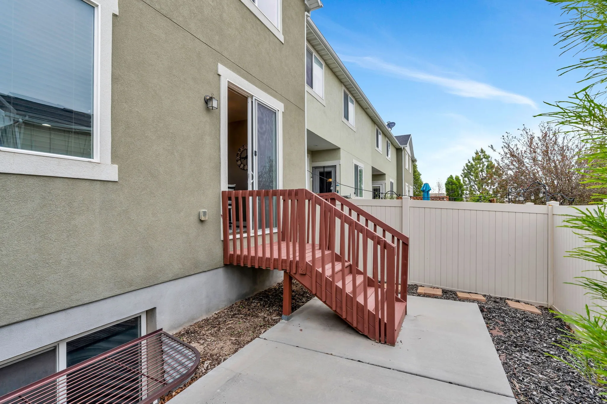 Stucco exterior with a ground-level concrete patio