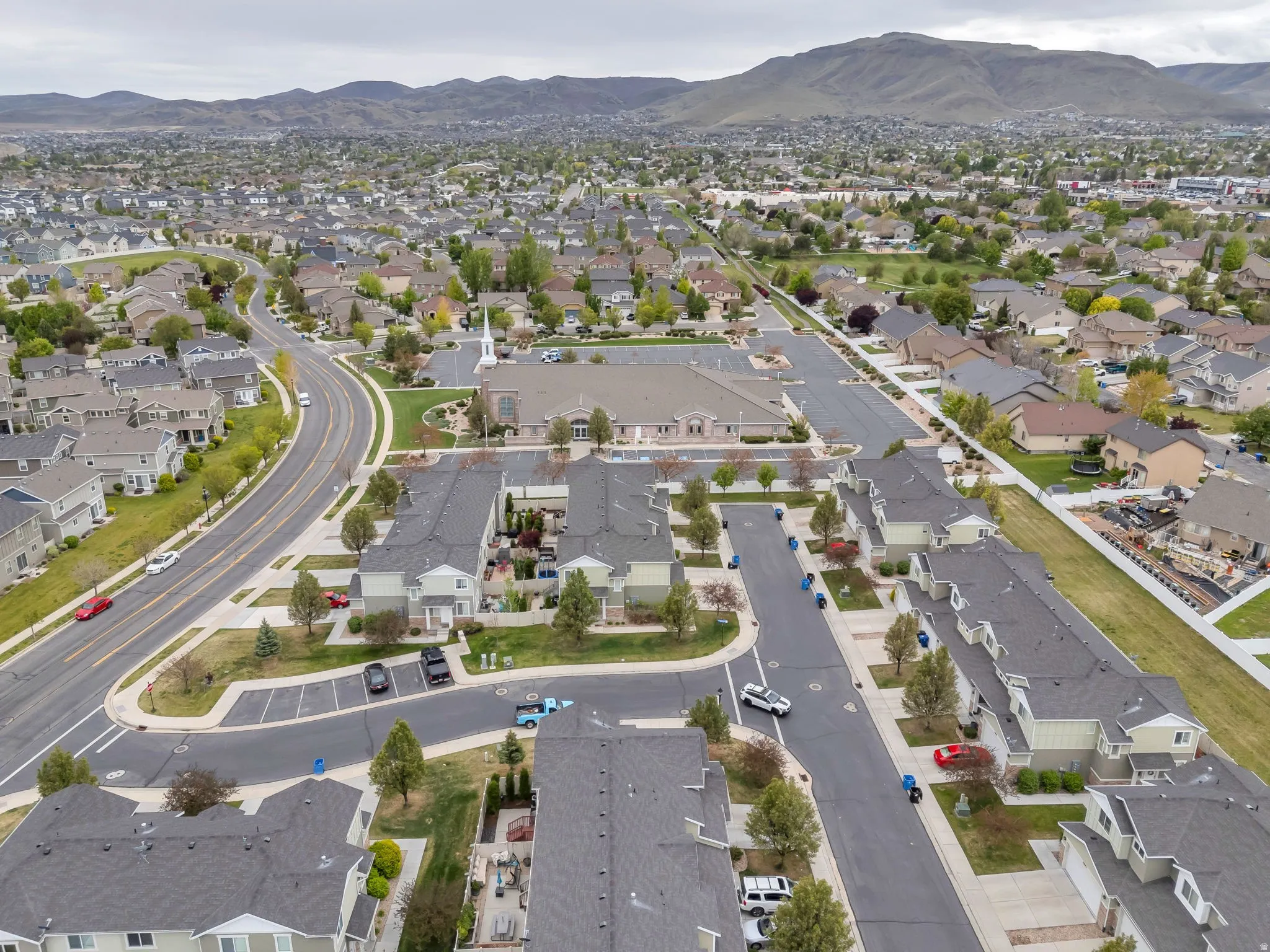 Expansive community featuring residential housing, paved roadways, and landscaped common areas