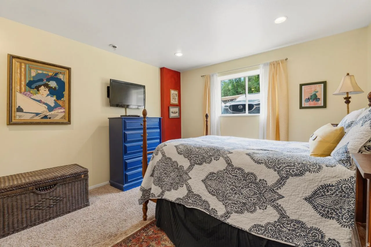 Primary bedroom with a walk in closet & great natural lighting. Room comes with Carpet, recessed lighting and a window with natural light