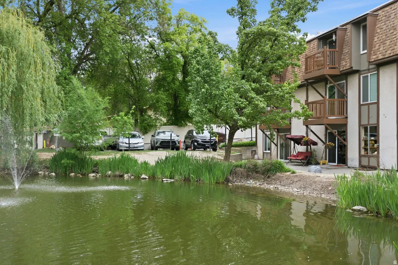 Your view from your back entry featuring a fountain, mature trees, & a private area to relax.