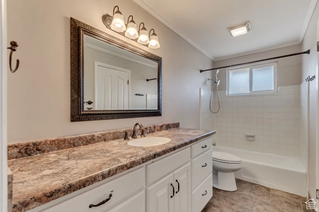 Bathroom with vanity,  shower combination, and ornamental molding