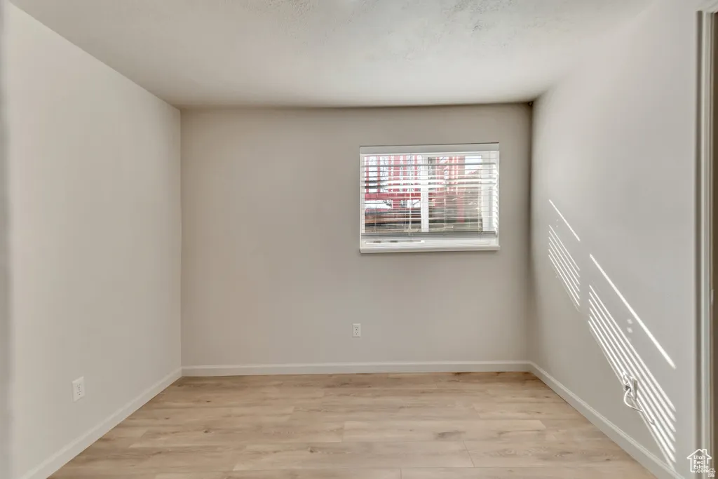 Spare room with light wood-type flooring and baseboards