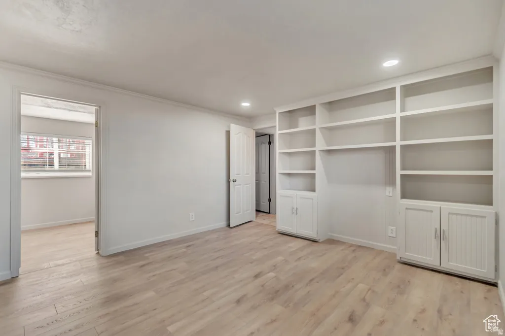 Unfurnished bedroom featuring light wood-style floors, recessed lighting, and crown molding