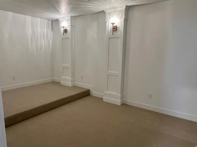 Spacious room featuring neutral carpeting and white walls