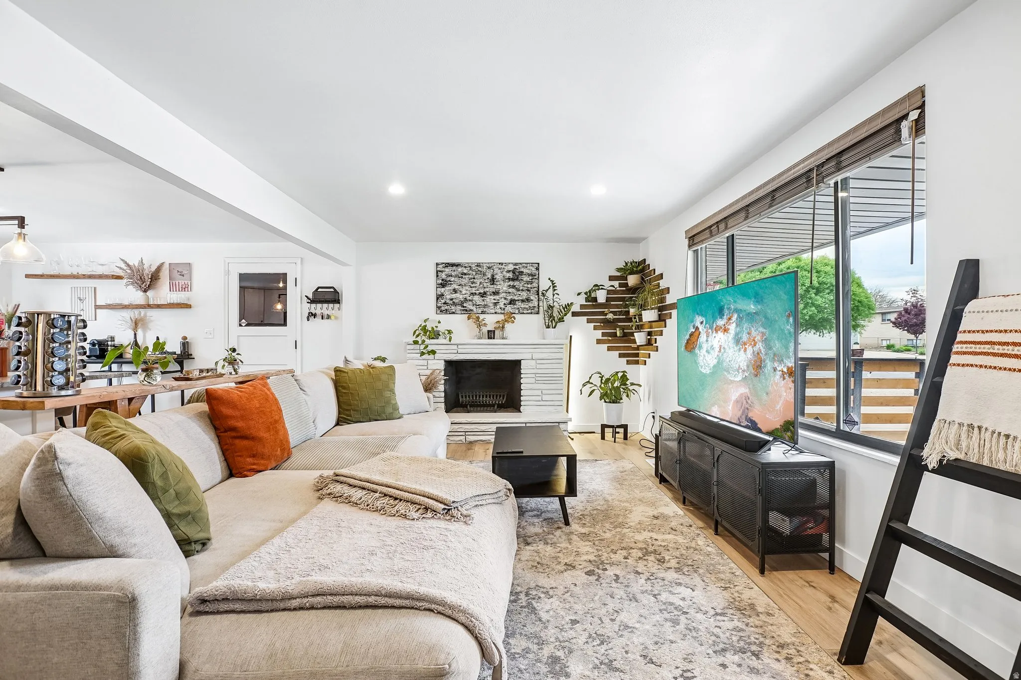 Living area with light wood-finish flooring and an area rug