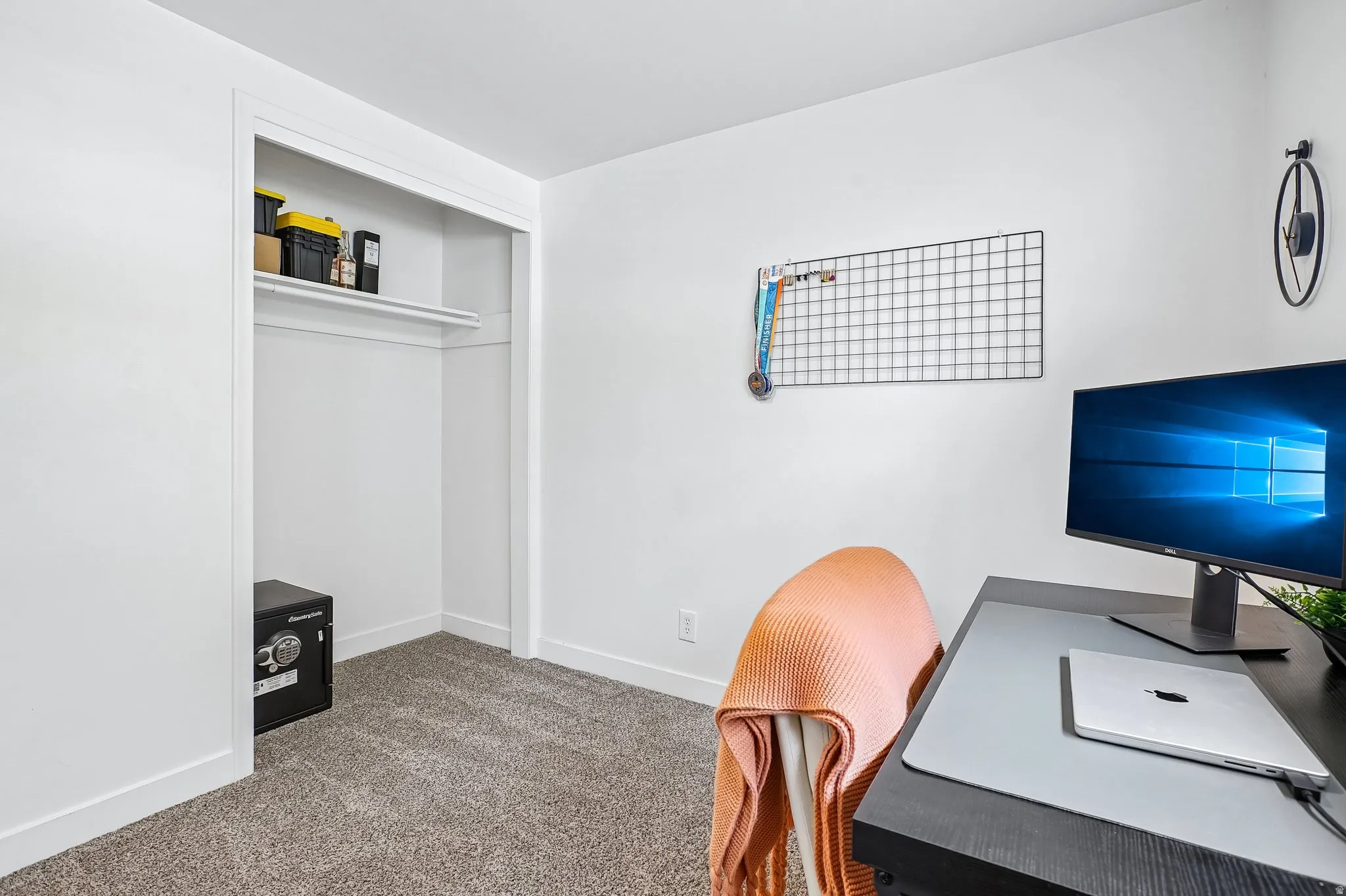 Neutral-toned carpeting paired with white baseboards and walls