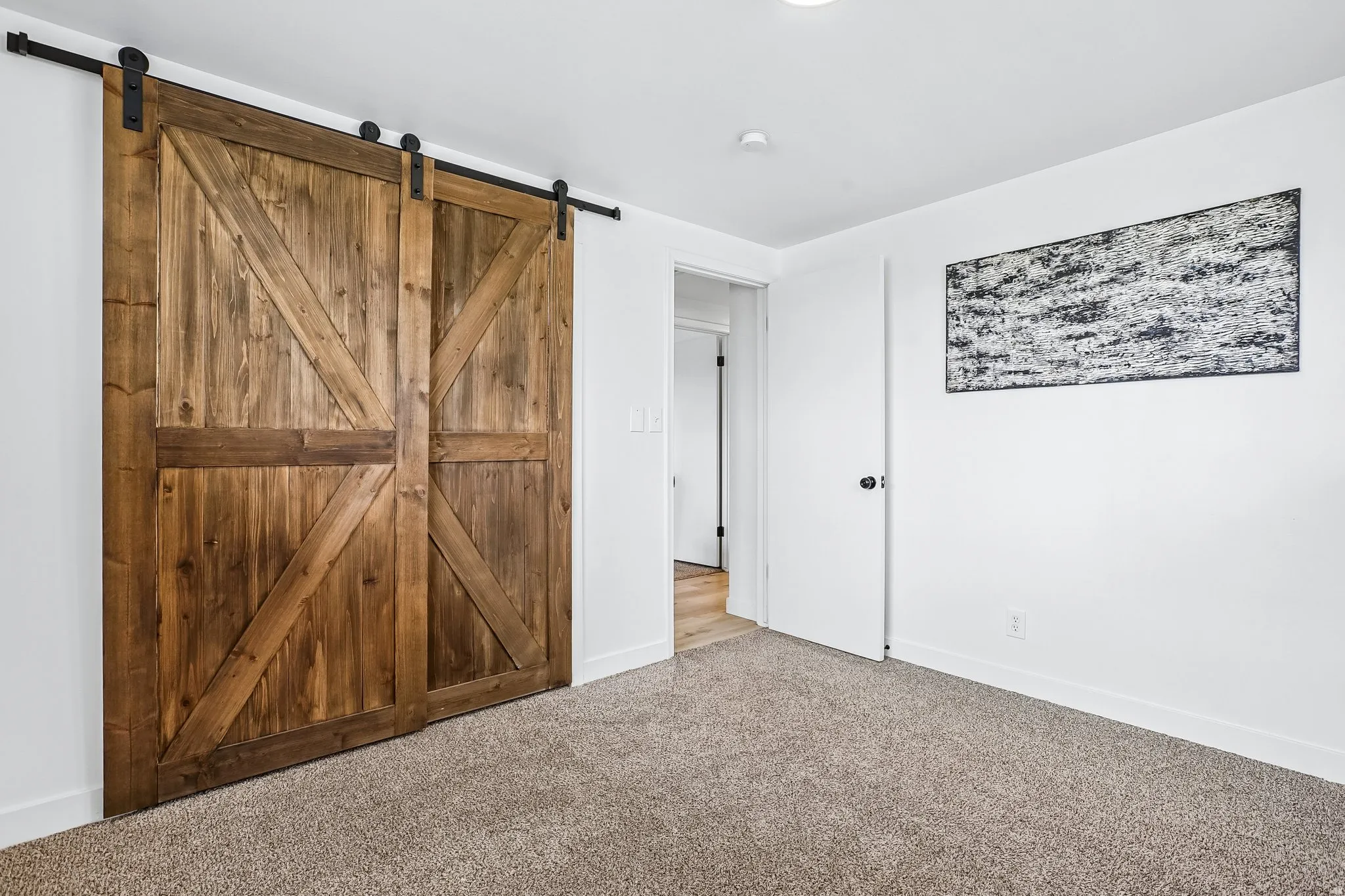 Barn door with exposed wood grain and black hardware